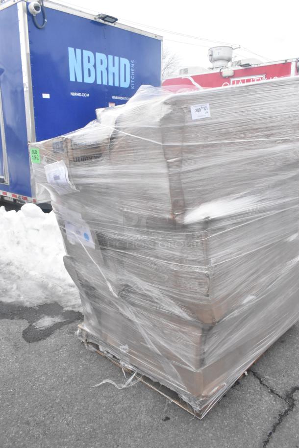 Pallet of 10 brand new "scratch and dent" items wrapped in plastic, including chair and hand sink, outside near trucks.