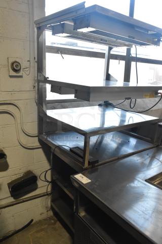 Commercial multi-shelf merchandiser display with warming strips, stainless steel, multiple tiers, includes electrical wiring, good condition.