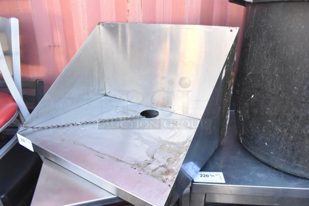 Stainless steel shelf with a protective back panel, visible chain, and circular cutout. Moderate wear, auction label attached.