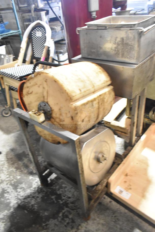 Commercial floor style unit with large cylindrical drum, metal frame, and attached square container; used condition.