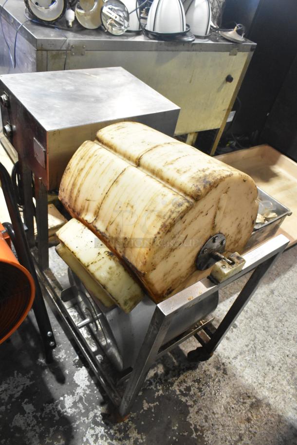 Commercial floor style unit with a stainless steel frame and large cylindrical components. Visible wear and discoloration.