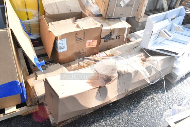 Seven new scratch and dent items, including Avantco over shelf and Watts grease trap, in damaged packaging on a pallet.