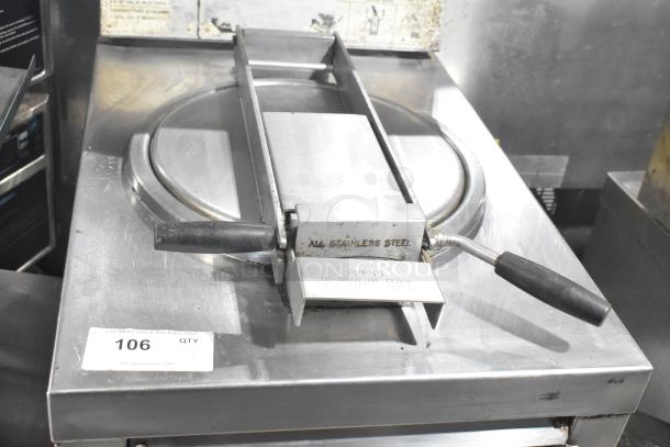 Commercial floor-style pressure fryer, stainless steel, visible wear. Features control handles and safety markings. Lot tag 106.