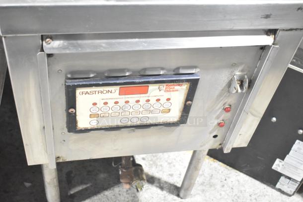 Commercial floor-style pressure fryer with Fastron microprocessor control panel, stainless steel body, used condition.