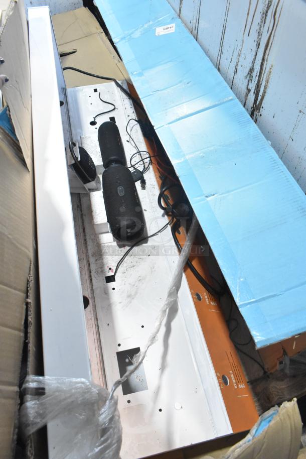 2 items including a B Series soundbar and speaker, visibly used, with cords, in original packaging. Box shows signs of wear.