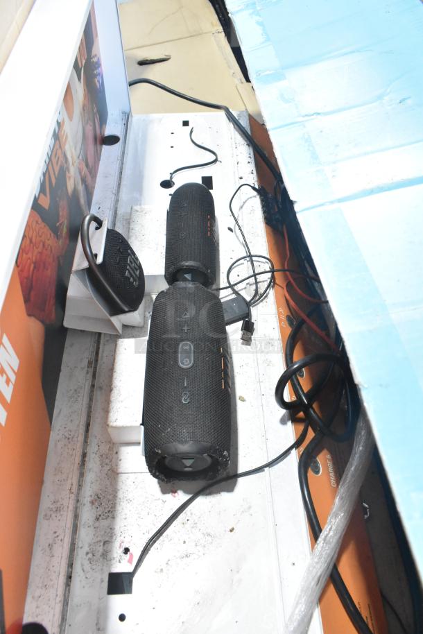 Black B Series soundbar and speaker set, lightly used condition, visible power cables, promotional packaging.