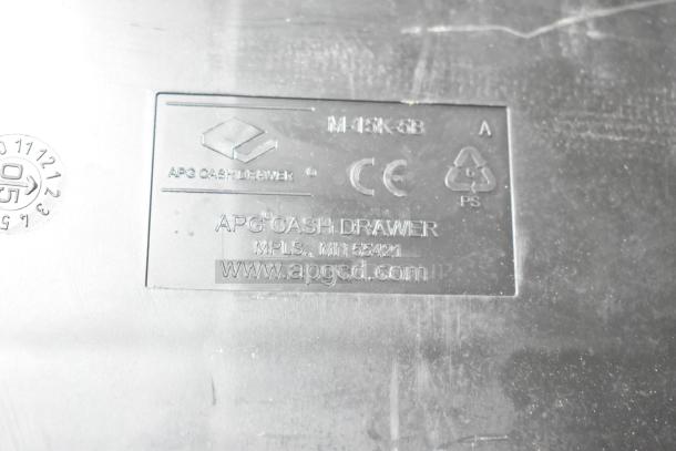 Lot of 3 black poly cash register inserts, APG Cash Drawer brand, model M-15K-5B, visible label with manufacturer info.