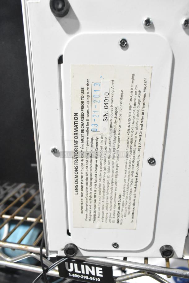 Close-up of a Wi-Fi speaker base with visible label. Label includes usage instructions and serial number 04010.