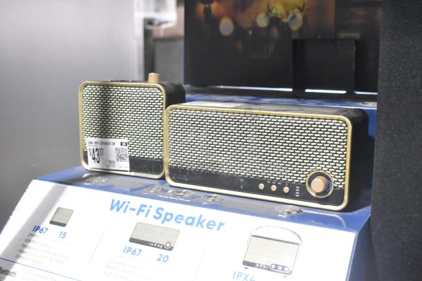 Set of two vintage-style Wi-Fi speakers with gold borders, displaying a $43.37 price tag and technical specifications on a labeled stand.