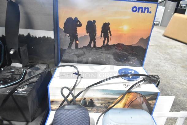 Sony display with integrated speakers, headphones, and Onn speakers on display. Includes cables. Price tag: $34.88.