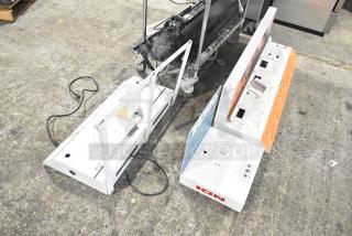 Three white display stands, marked "ION," with graphics on one side. Used condition, visible wiring and mounting holes.