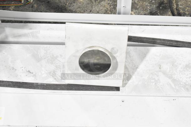 White display stand with circular cutout, featuring a slightly worn surface, suitable for showcasing items.