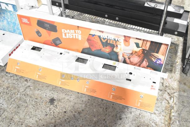 JBL promotional display stand featuring headphones and speakers, with vibrant graphics and text "Dare to Listen." Good condition.