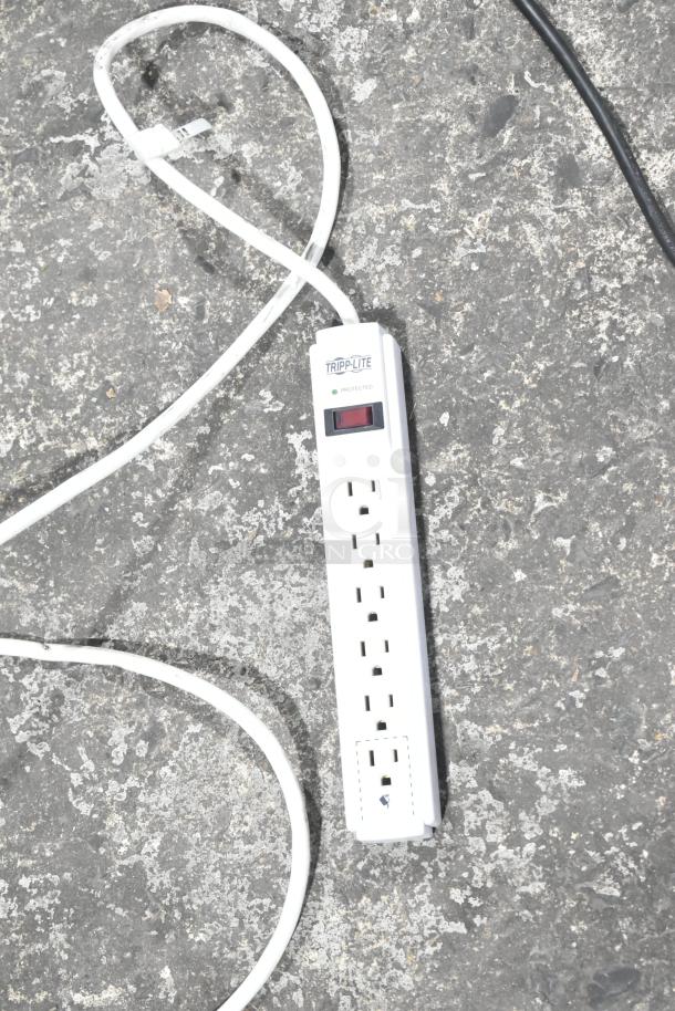 Tripp Lite power strip with six outlets, white, surge protection indicator, in good condition.