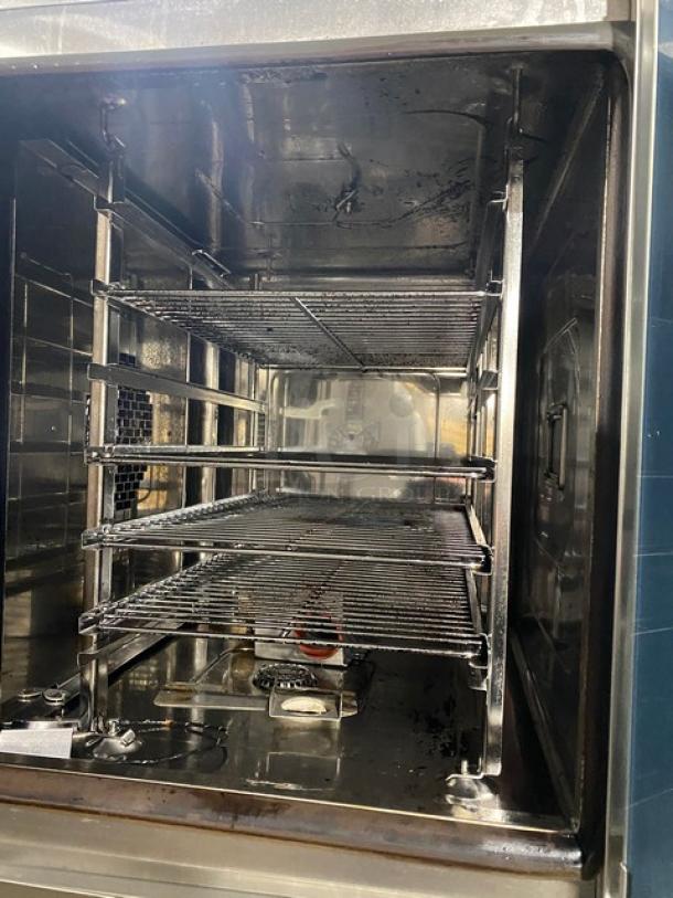 Rational ClimaPlus Series stainless steel double stacked combi steamer oven, model CPC61/CPC101, with built-in pan rack and on legs.