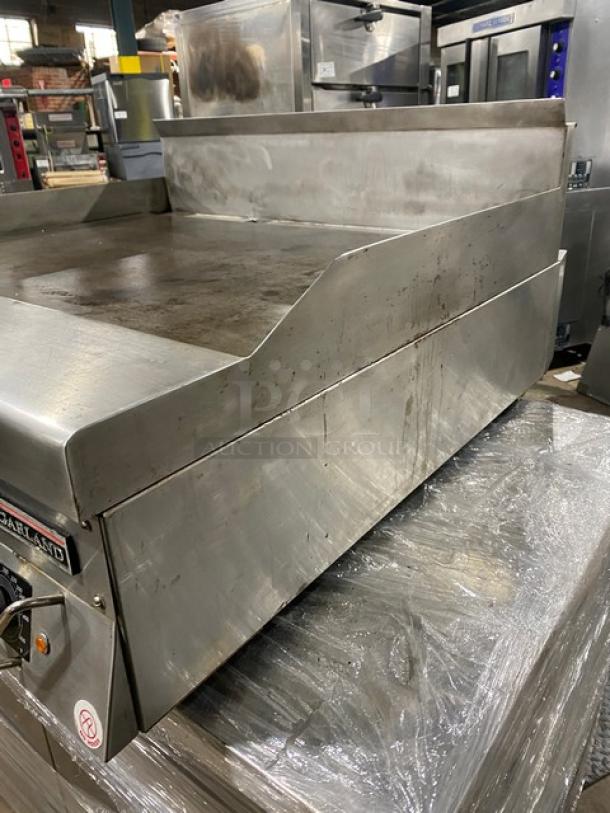 Garland commercial stainless steel gas griddle with back and side splash, thermostatic control. Used condition.