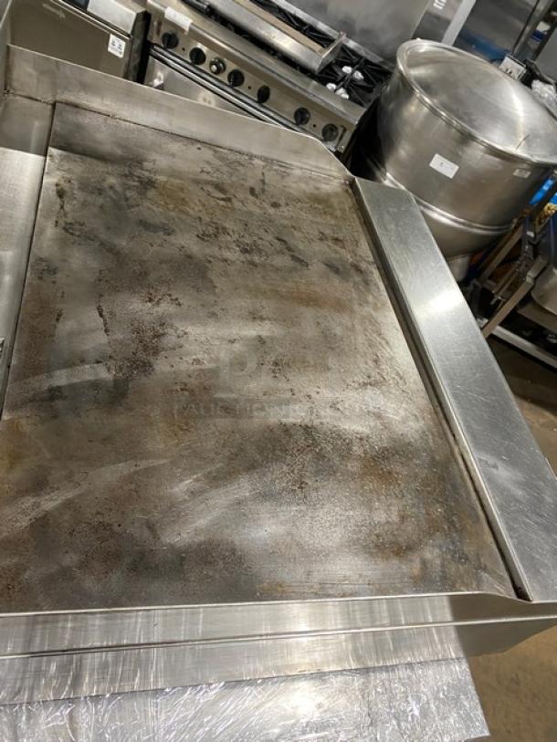 Garland commercial stainless steel gas griddle with back and side splash, thermostatic control. Used condition.