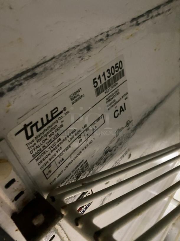 True TUC-48 Commercial 2-Door Worktop Refrigerator, stainless steel, with poly-coated wire rack, model, serial, and spec label visible.