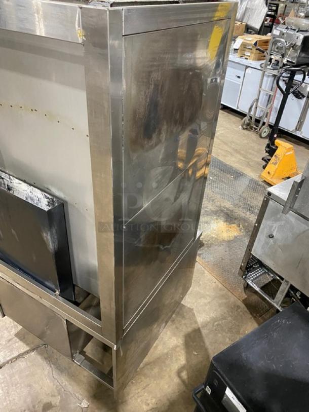 Commercial stainless steel 3-compartment gas seafood steamer with individual controls and wired oven rack on legs.