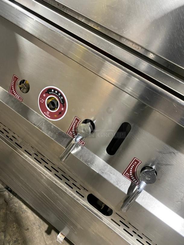 Commercial stainless steel gas-powered 3-compartment seafood steamer with individual controls, wired oven rack, on legs, good condition.