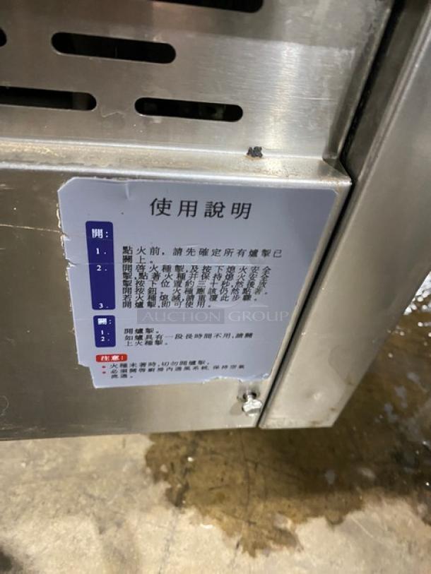 Commercial stainless steel gas-powered 3-compartment seafood steamer. Features individual controls, wired oven rack, and sturdy legs. Instructions in Chinese visible on the side panel.