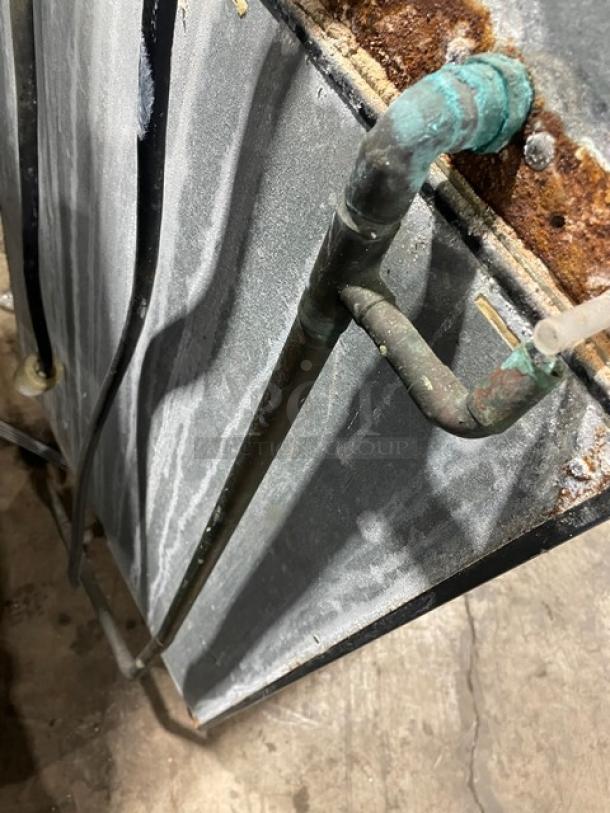 Hoshizaki KM-515MAH ice machine, stainless steel, air-cooled, electric, 115-120V, visible wear and corrosion on piping.