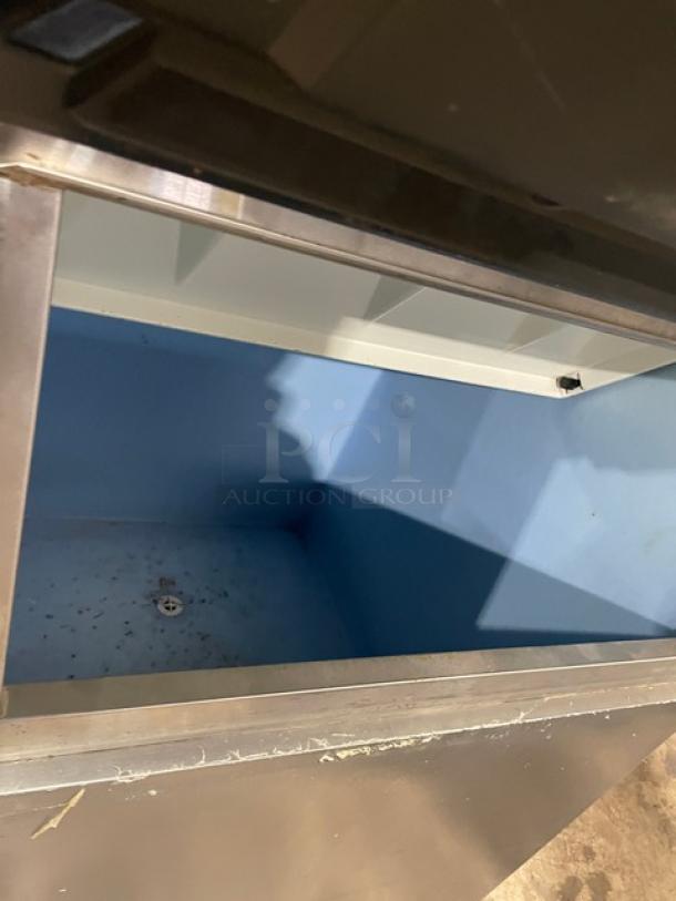 Hoshizaki KM-515MAH ice-making machine in stainless steel, open bin view, electric-powered, air-cooled, on legs.