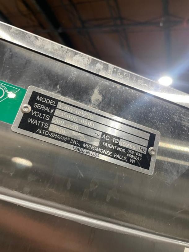 Alto-Shaam 1200UPSR stainless steel Dutch door cabinet label, showing model and serial number details.