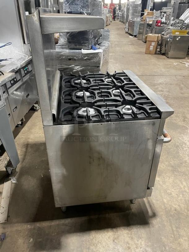 Imperial stainless steel 6-burner gas range/oven combo with overhead salamander shelf, backsplash, and wired oven rack.