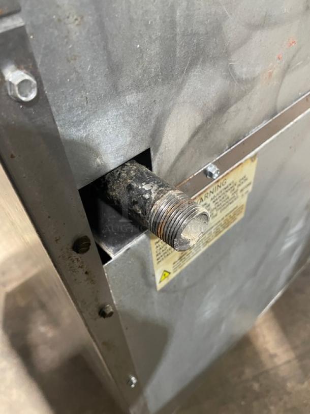 Imperial commercial range/oven combo, stainless steel, natural gas, shows gas pipe and warning label, used condition.