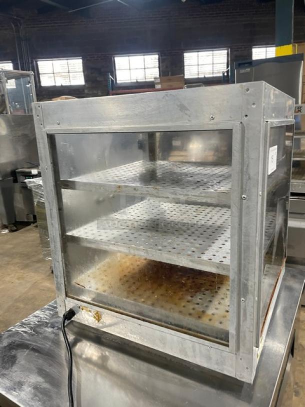 HeatMax stainless steel countertop pizza/food warmer display case on legs; features three perforated shelves, visible power cord, used condition.