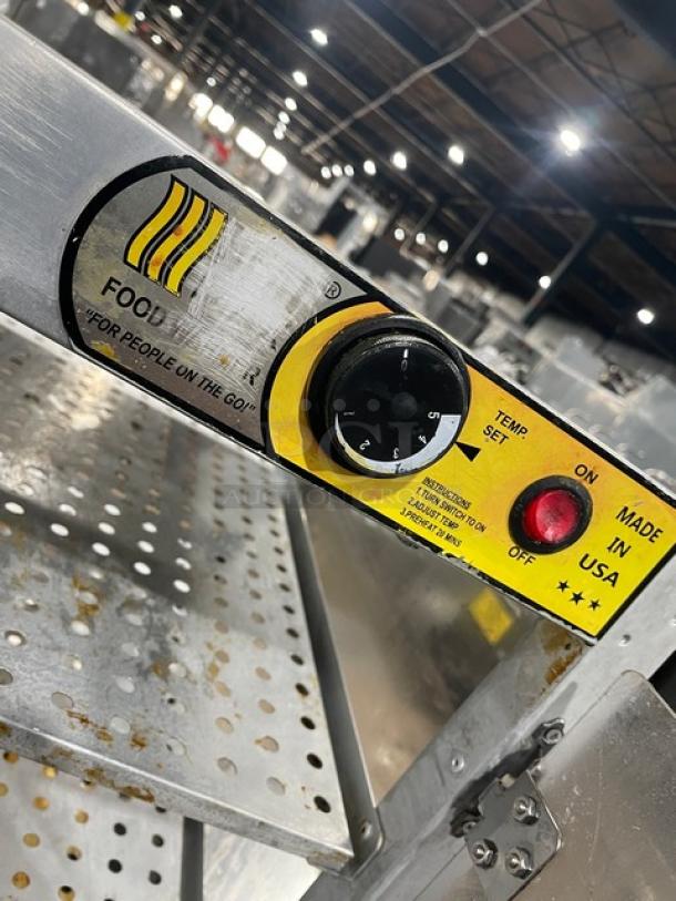 HeatMax stainless steel countertop pizza/food warmer display case on legs, visible temp control, and "Made in USA" label.