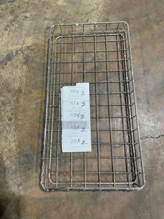 Chrome-plated steel stackable rectangular wired food storage basket, open-air design, with dimensions list on a tag.