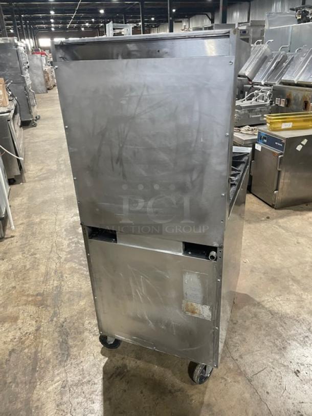 Southbend stainless steel 4-burner range/oven combo with overhead salamander shelf, backsplash, and wired oven rack, Model S241E, on casters.