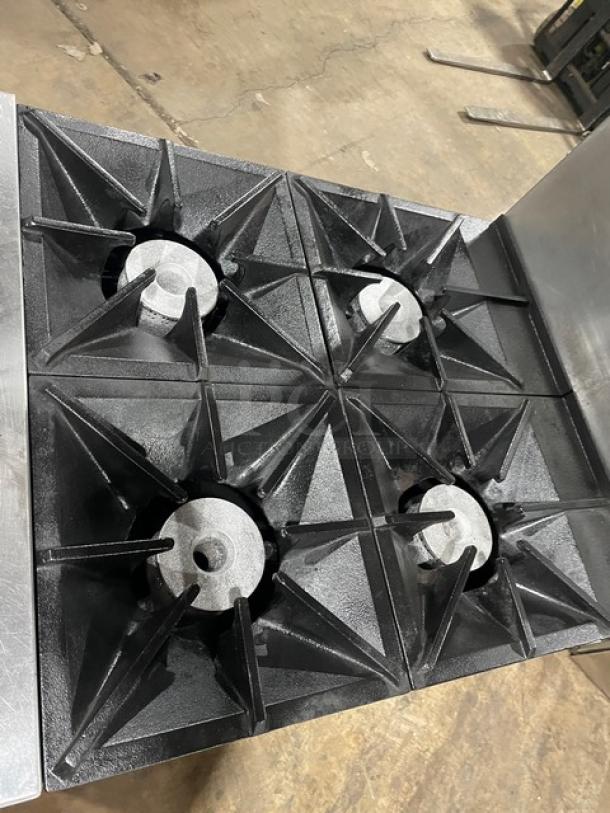 Southbend S241E commercial stainless steel 4-burner range with overhead salamander shelf, backsplash, and wired oven rack.