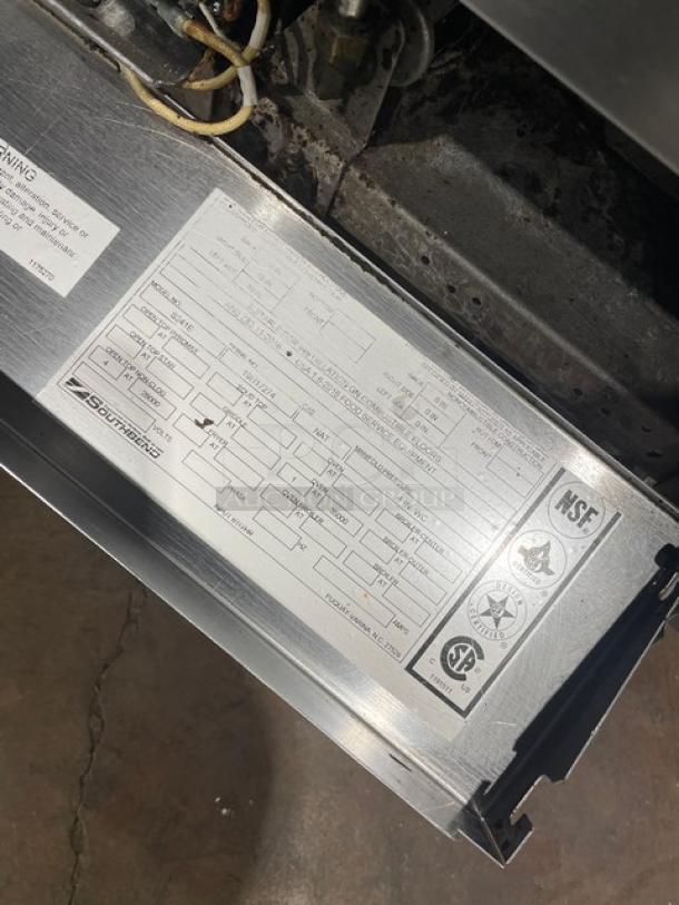 Southbend stainless steel 4-burner range/oven combo, model S241E, serial 19H17274, with overhead salamander shelf, backsplash, and wired oven rack, on casters. NSF certified.