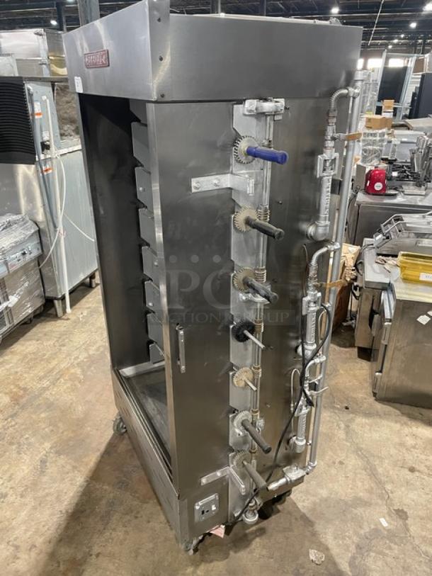 Attias stainless steel gas-powered full-height rotisserie cabinet on casters, commercial-grade, features control panel, good condition.