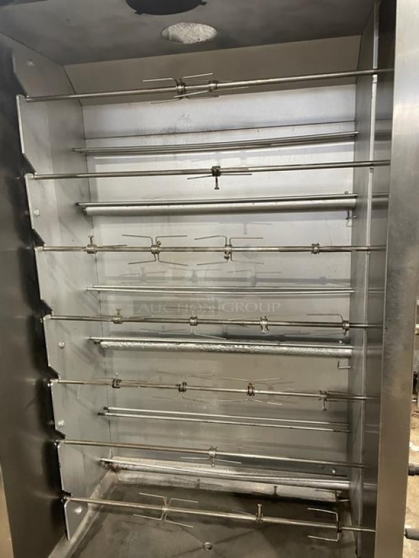 Attias stainless steel full-height rotisserie cabinet; gas powered, on casters. Multiple rotisserie spits, commercial use.