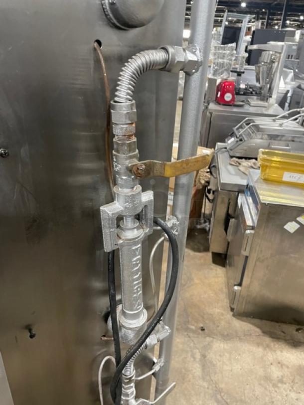 Attias stainless steel gas-powered rotisserie cabinet on casters, industrial connections visible, used condition.