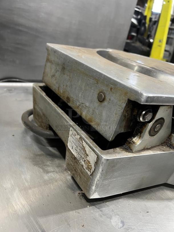 Caliente Industries model A1 stainless steel electric tortilla press, countertop design, visible wear, 115-125/208-240V.