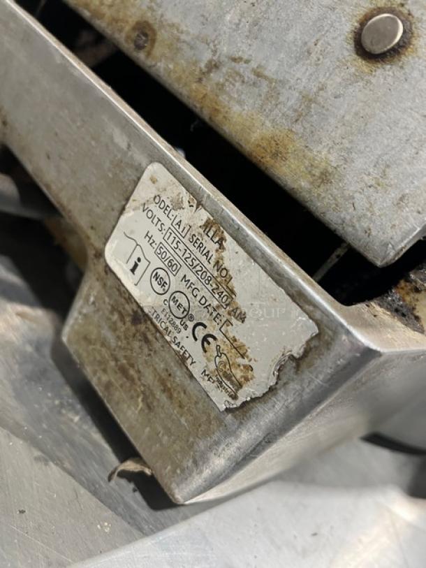 Caliente Industries A1 commercial stainless steel electric tortilla press cooker/warmer, visible label indicates voltage specs, used condition.