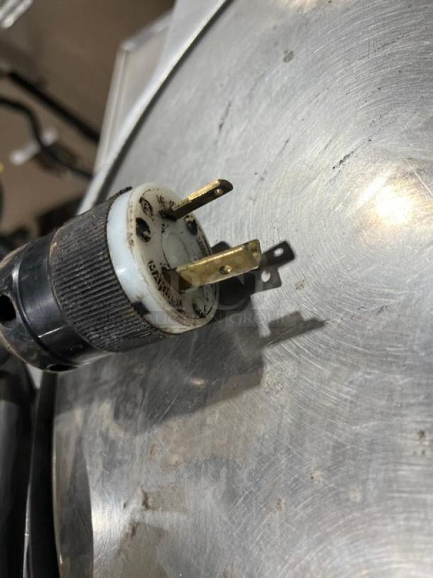 Caliente Industries A1 stainless steel electric tortilla press plug detail; slightly worn, 115-125/208-240V compatibility.