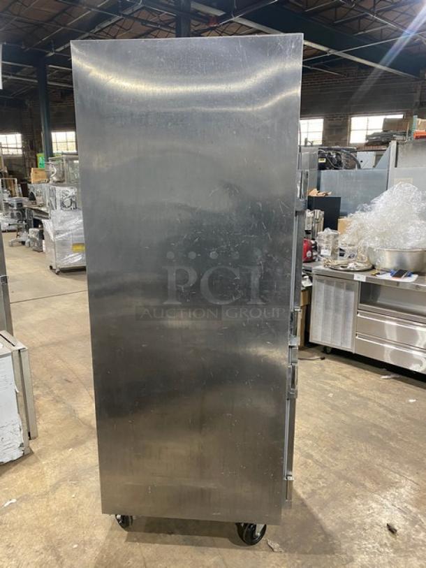 Traulsen stainless steel reach-in refrigerator, model AHT132DUTHHS, half-door, on casters, wired racks included.