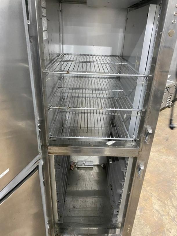 Traulsen commercial stainless steel refrigerator, model AHT132DUT-HHS, with wire racks, half door, on casters.