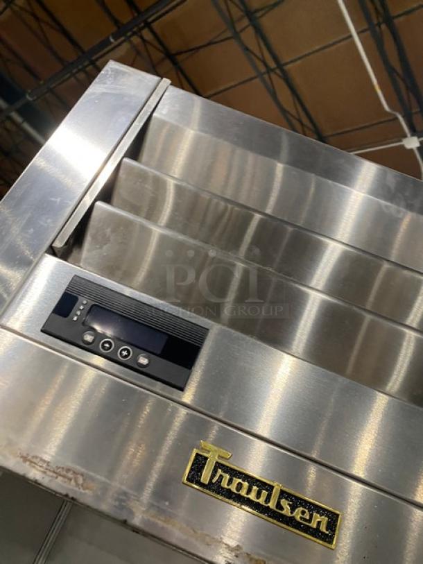 Traulsen AHT132DUTHHS commercial stainless steel refrigerator, solid half door, wired racks, digital control panel, on casters.