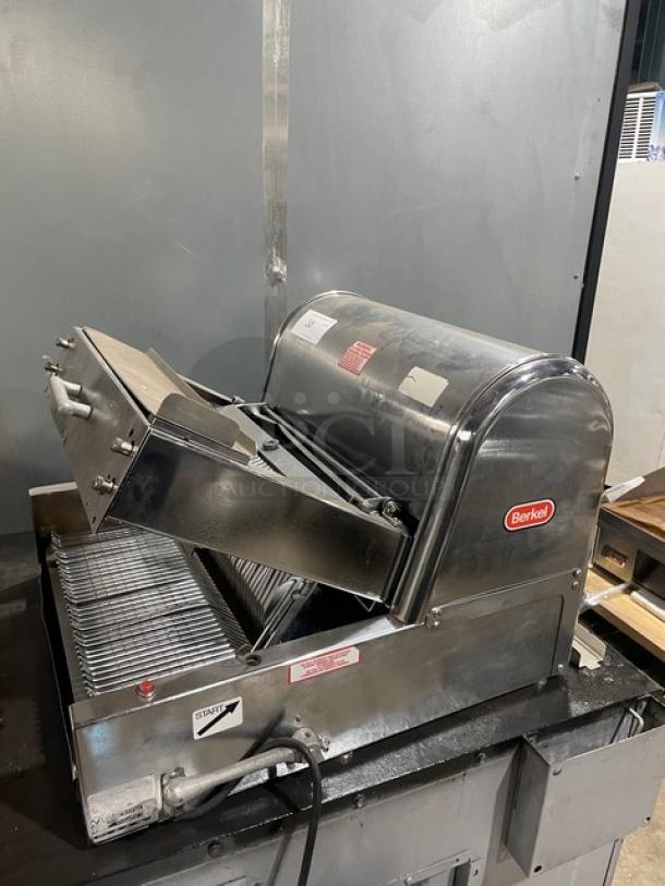 Berkel commercial stainless steel electric bread slicer, countertop model, in good condition with visible brand logo and controls.
