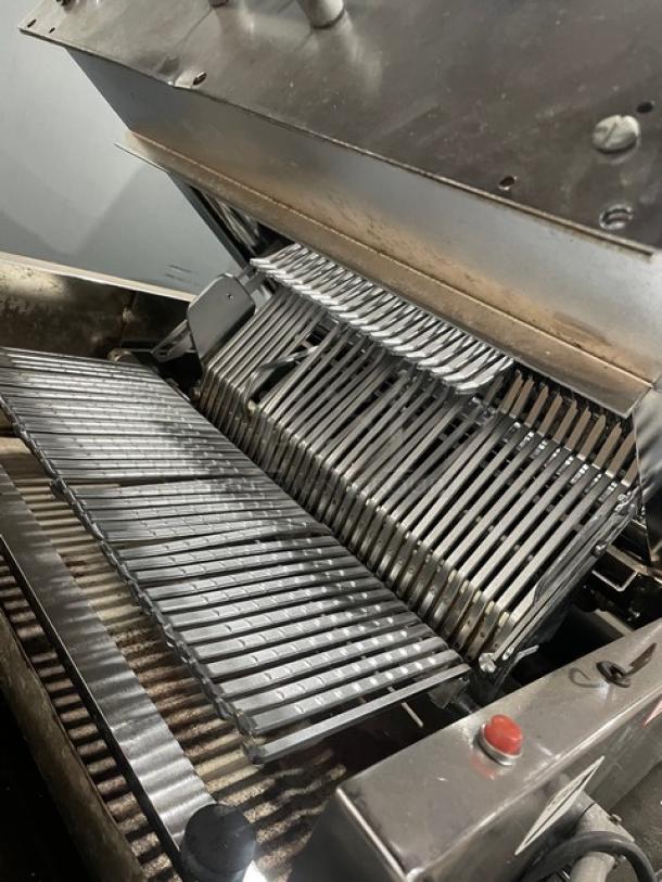 Berkel commercial stainless steel electric bread slicer; countertop model, visible slicing blades, sturdy build, good condition.