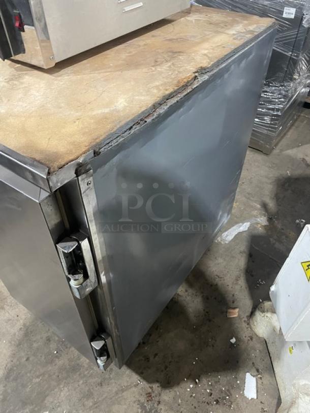Leader 2-door stainless steel refrigerated pizza dough retarder table, model DR48SC, on casters. Visible wear on edges.