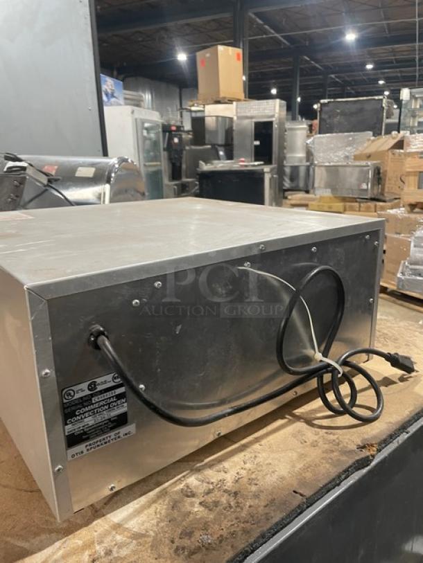 Otis Spunkmeyer OS1 stainless steel convection oven, electric-powered, includes 3 baking trays, 120V, SN: C0090295.