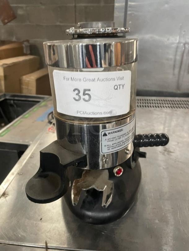 HeyCafe HC600 electric espresso grinder, stainless steel, on legs. Shows auction label "35 QTY". Serial: 0002719, 110V.